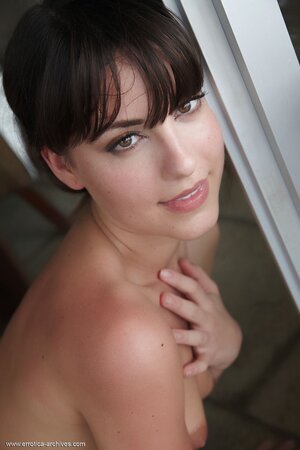 Attractive young lady with tiny tits poses all naked in the living-room