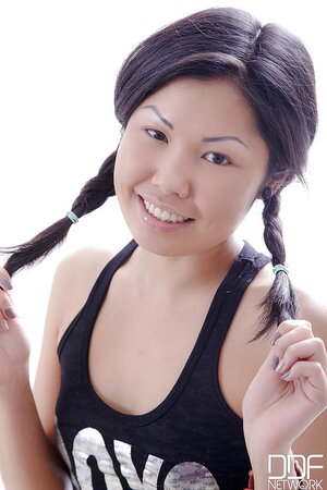 Sexy Asian hussy undresses slowly and flaunts her body on the massage table