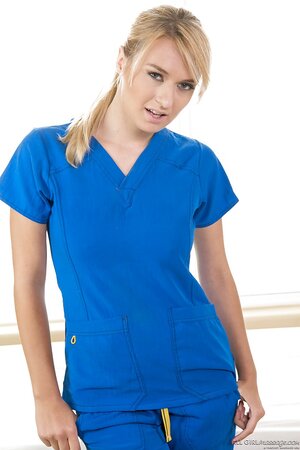 Hot blond masseuse poses on the massage table and pulls off her uniform