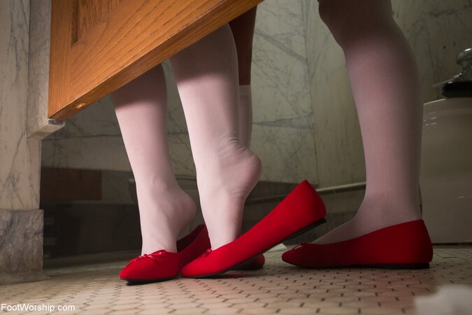 Red-haired lesbian schoolgirls take off socks and caress pink feet in the toilet