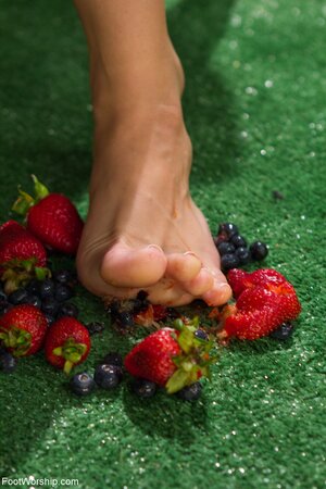 Two horny lezzies squash berries with feet and lick toes before riding dildo
