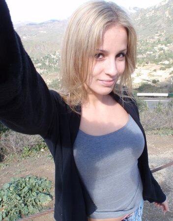 Cock-hungry blonde chick rubs pussy while filming herself in the mountains