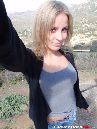 Cock-hungry blonde chick rubs pussy while filming herself in the mountains