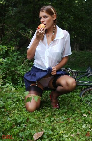 Naughty schoolgirl in stockings doesn’t hesitate to undress in the orchard