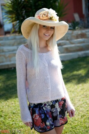 Charming honey in a hat peels clothes to spread perfect legs and show wet pussy