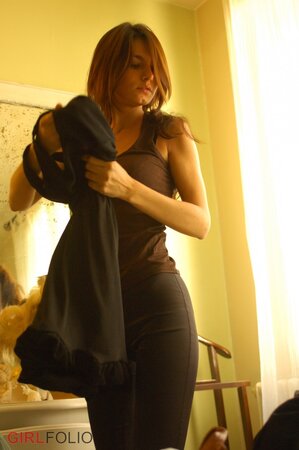 Adorable lassie changes lingerie while erotically posing naked by the mirror