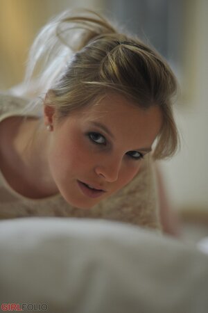 Adorable blonde lassie in lingerie exposes perky assets in various erotic poses