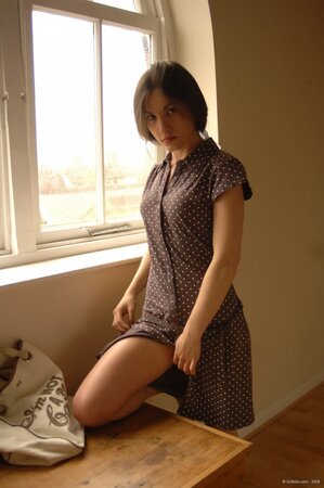 Skinny teen has no shame to strip and pose totally nude in front of the window