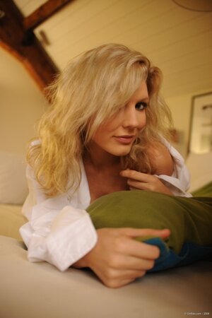 Adorable blonde lassie sensually undresses to expose her beautiful young body