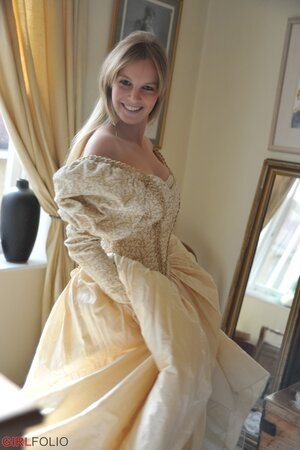 Gorgeous blonde discards vintage dress till she is left in corset and stockings