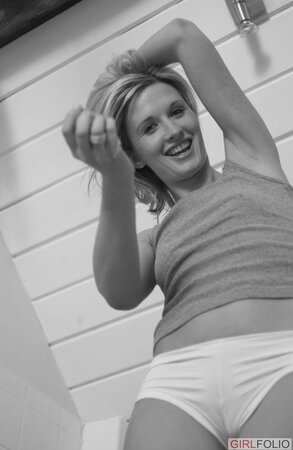Blonde housewife walks around the house and strips naked for the camera