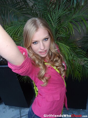 Tempting blonde doll with small tits undresses to pose for nude photos