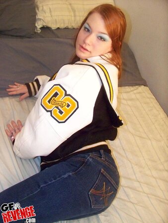 Red-haired teen whore exposes her immense natural breasts and shaved twat