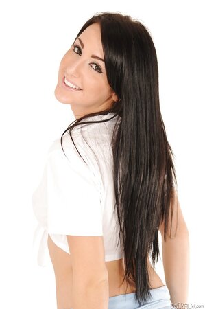 Lovely black-haired colleen pulls off school uniform to pose completely naked