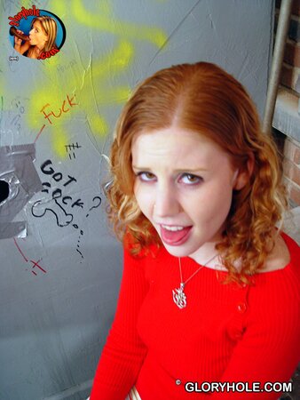 Red-haired babe tastes black dong in gloryhole room and swallows jizz