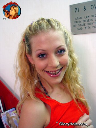Playful blond teen with small tits improves sucking skills in gloryhole room