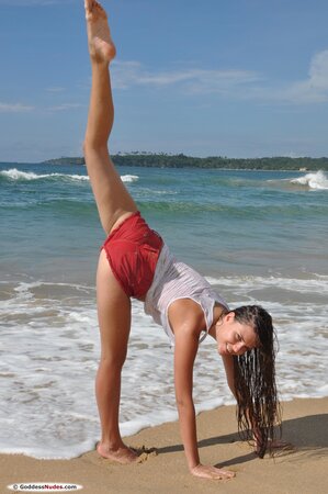 Angelic teen hussy shows off her awesome body stripping on the sandy beach