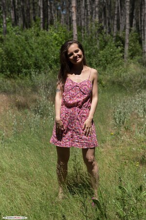Adorable bimbo enjoys displaying naked body during walk in the forest