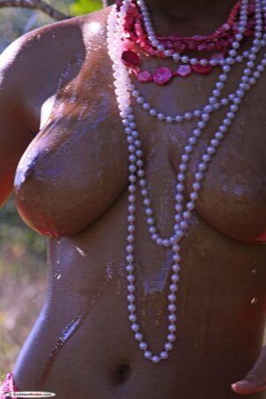 Luscious Ebony chick wets her perky tits during erotic modelling outdoors