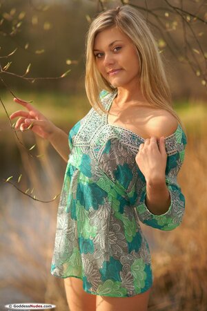 Playful blond babe discards dress to expose small boobs and smooth peach