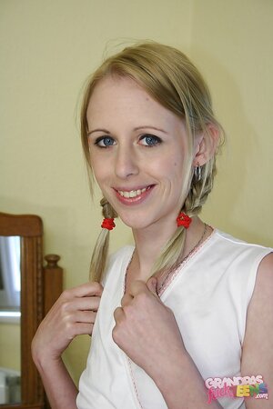 Skinny teen with pigtails undresses to expose her tiny tits and coochie