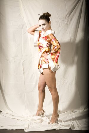 Lustful girl in Japanese geisha outfit reveals her tempting young curves