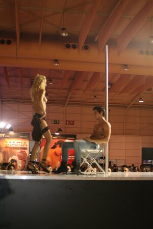 Seductive stripper knows how to turn crowd on with erotic pole dance