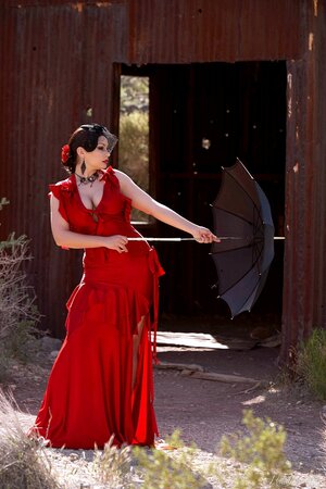 Elegant cougar puts umbrella away to flaunt her nice melons and smooth pussy