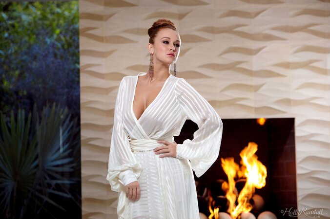 Cute brunette beauty sheds clothes to flaunt her big naturals by the fireplace