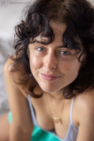 Curly girl with hairy armpits showing her crotch and then some