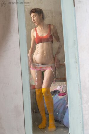 Self conscious looking girly girl  shows her thin body here