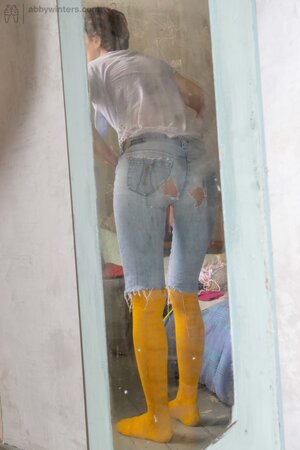 Self conscious looking girly girl  shows her thin body here