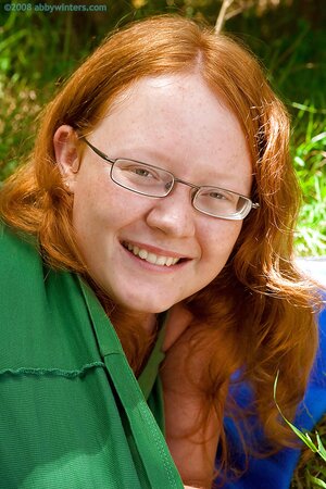 Redheaded seductress with a chubby bum is going to tease outside