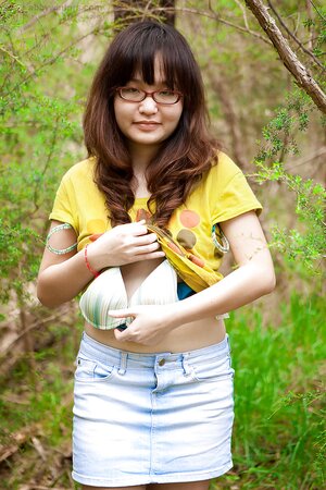 Adorable girl from Asia shows her firm backside as well