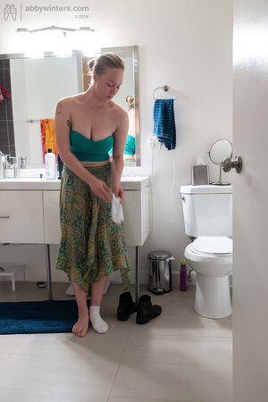 Blonde in a thong shows her backside while changing quickly