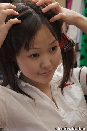 Asian schoolgirl shows upskirt and prepares for hard loving