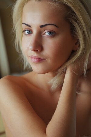 Blue eyed goddess Tooya shows her cooter on a big soft bed
