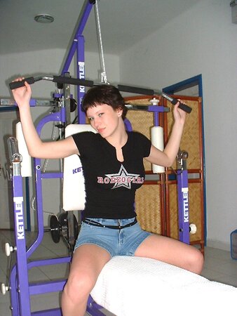 Hottie with short hair working out in the gym before stripping