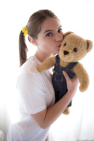 Innocent teen enters the room with Teddy in hands and puts it aside to strip