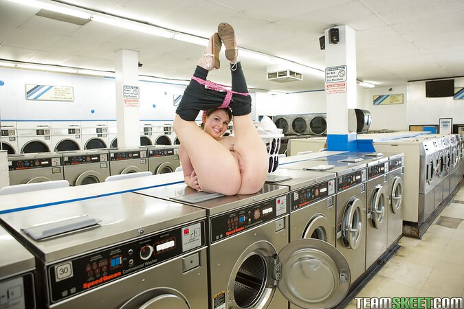 Beautiful housewife loads washing machine and has some time for obscene things