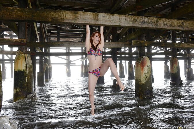 Sexy pornstar with red hair reveals tits and hairy pussy under a bridge