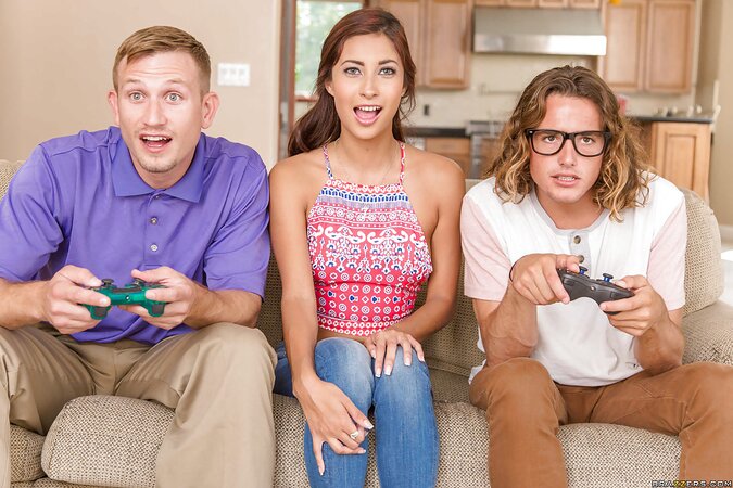 Latina with dyed hair takes the attention of two gamers