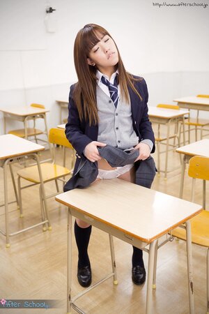 Asian teen decides to expose her bald cunt in the classroom