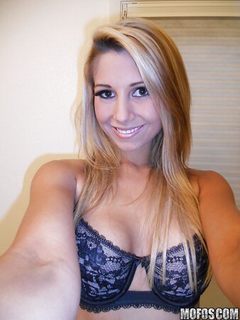 With a smile naughty blonde drops down lace lingerie whilst making selfies