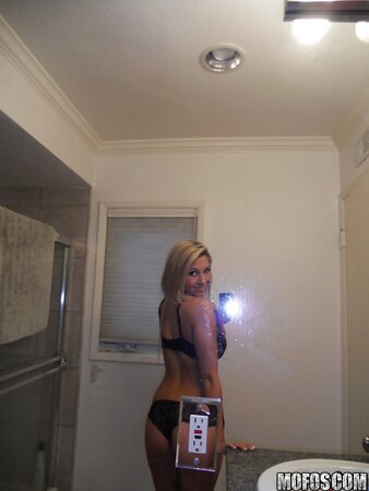 With a smile naughty blonde drops down lace lingerie whilst making selfies