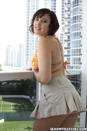 Attractive brunette takes off swimsuit to demonstrate nice body on the beach