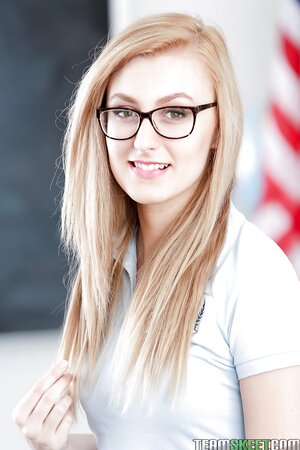 Petite schoolgirl with cute glasses shows off what is hidden under her uniform