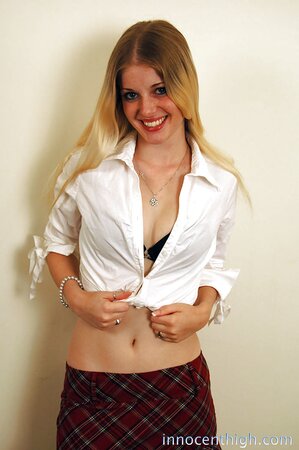 Sweet blonde smiles while lifting up short skirt to show her bubble butt
