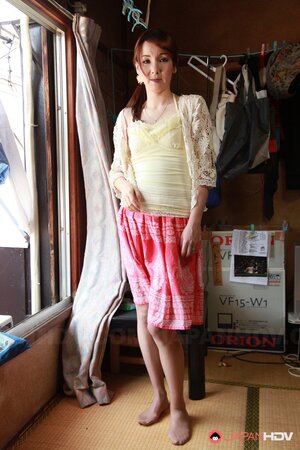 Red-haired Japanese housewife performs amazing strip show near window