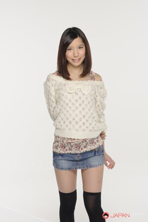 Young Japanese girl poses in short skirt that accentuates her long legs